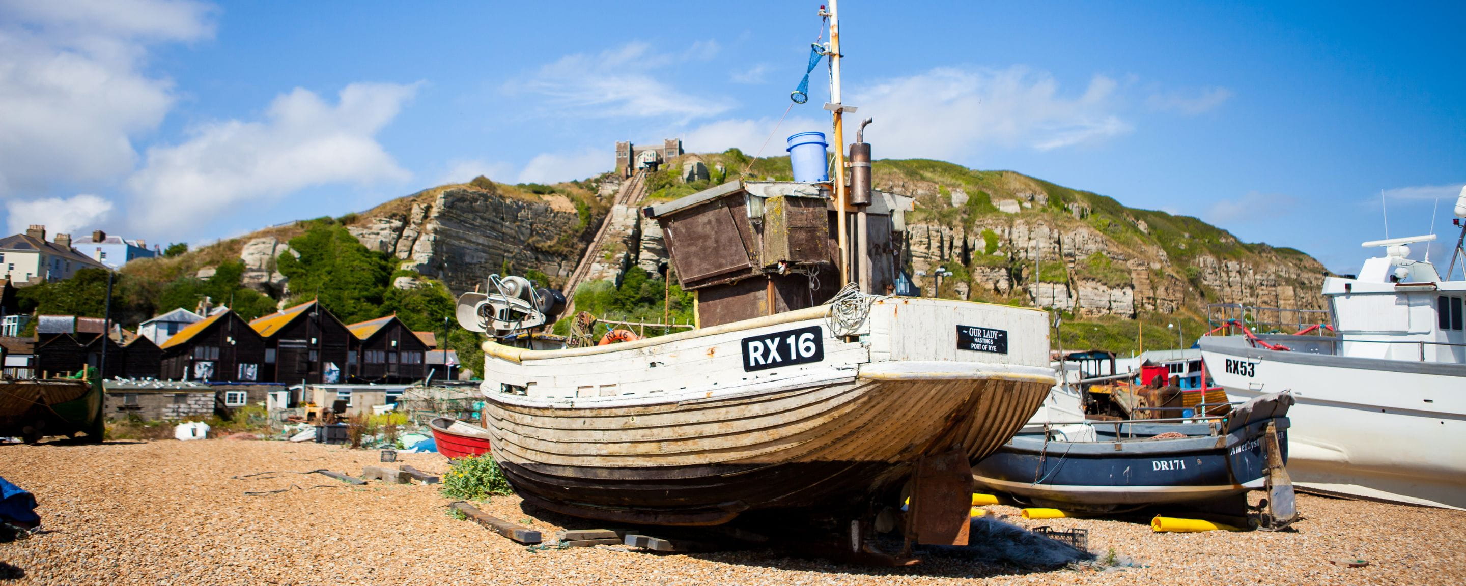 a fishing boat on the beach, Hastings funicular in the background