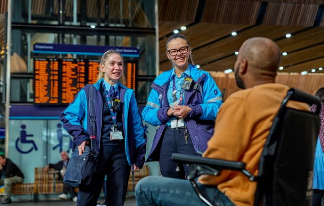 two Southeastern staff members assisting a wheelchair user