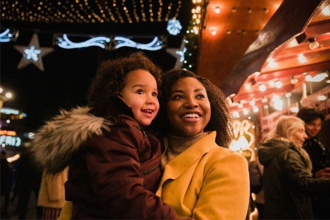 a mother and her daughter smiling at a fair