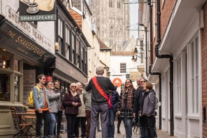 a group of people walking on a city street