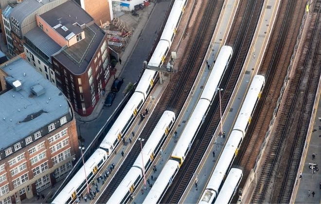 birdseye view of trains pulling into stations