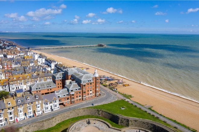 an aerial view over Deal beach with buildings to the left and sea to the right