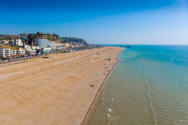 an aerial view over Hastings beach on a sunny day