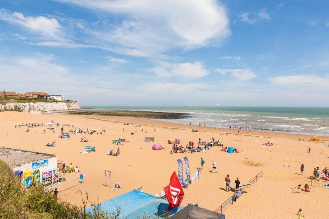 People on the beach visiting Joss Bay in Kent