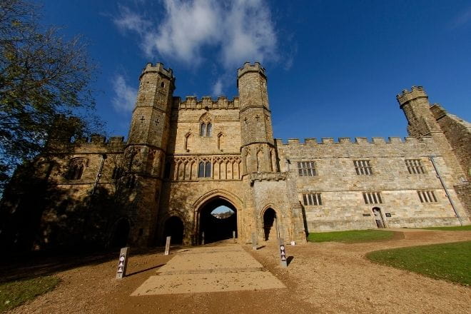 a large stone building with a tower in the background