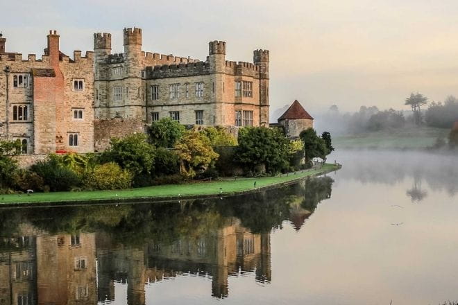 a castle with water in front of a body of water