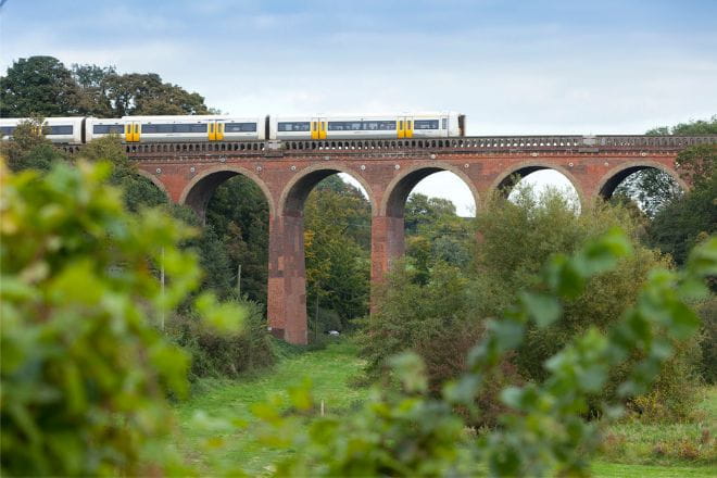 Southeastern train going over viaduct bridge in Kent Downs