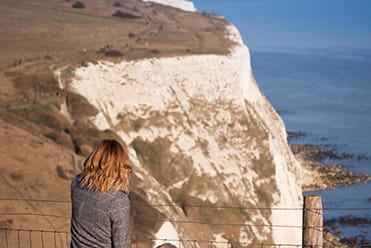 a person standing in front of a mountain