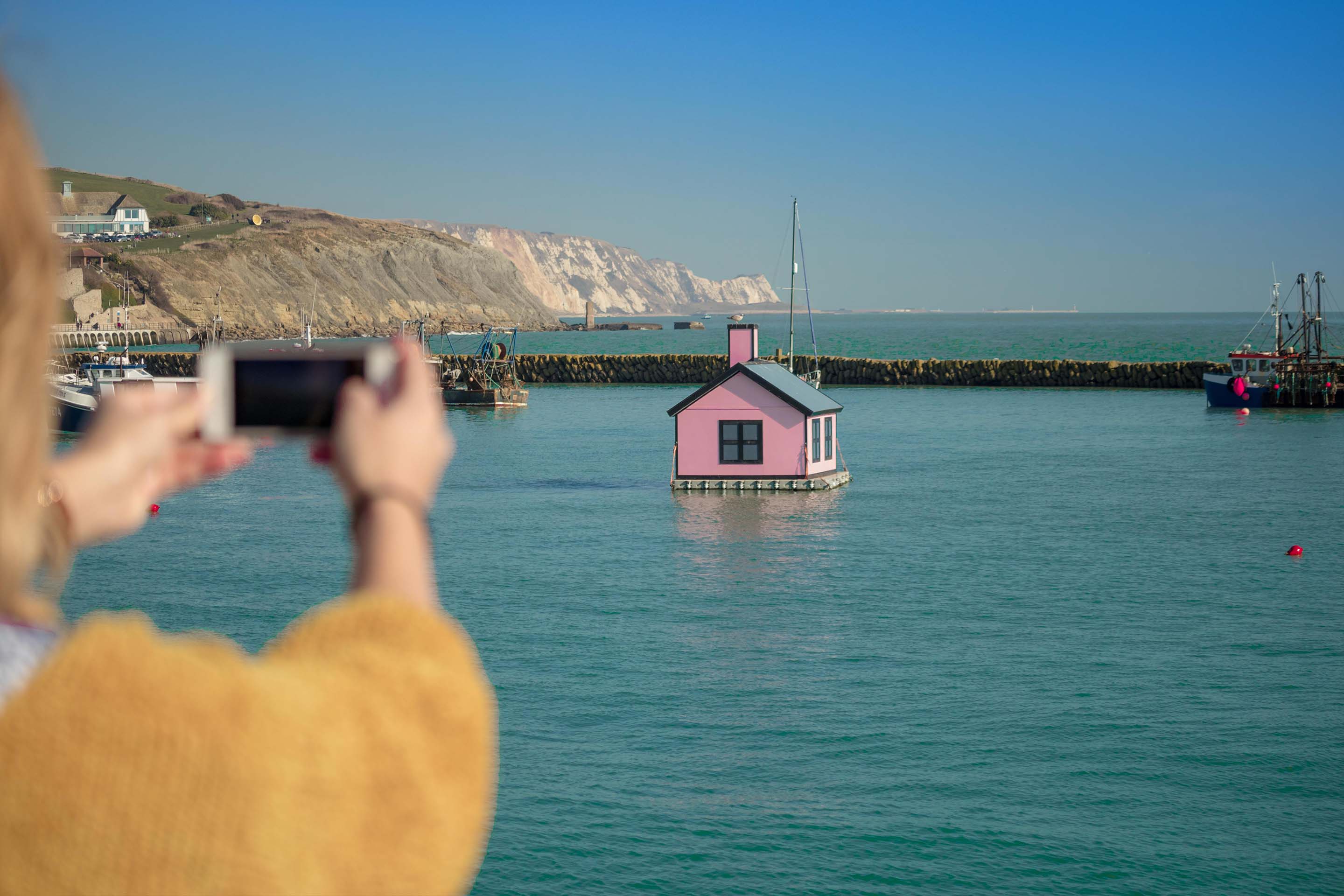 a man standing next to a body of water