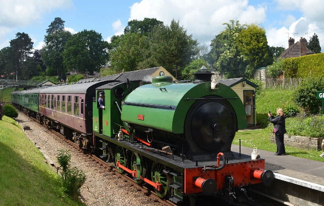 a steam engine is sitting on a train track