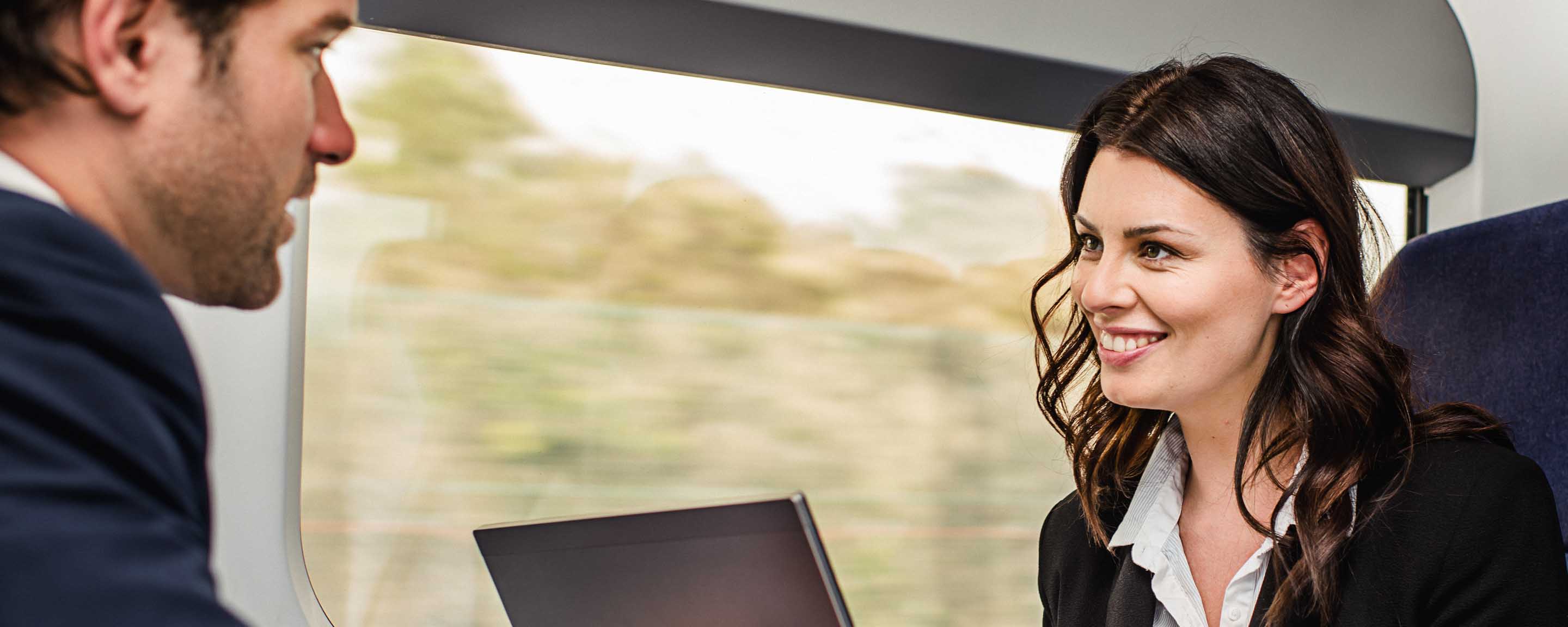 Man and woman on train chatting