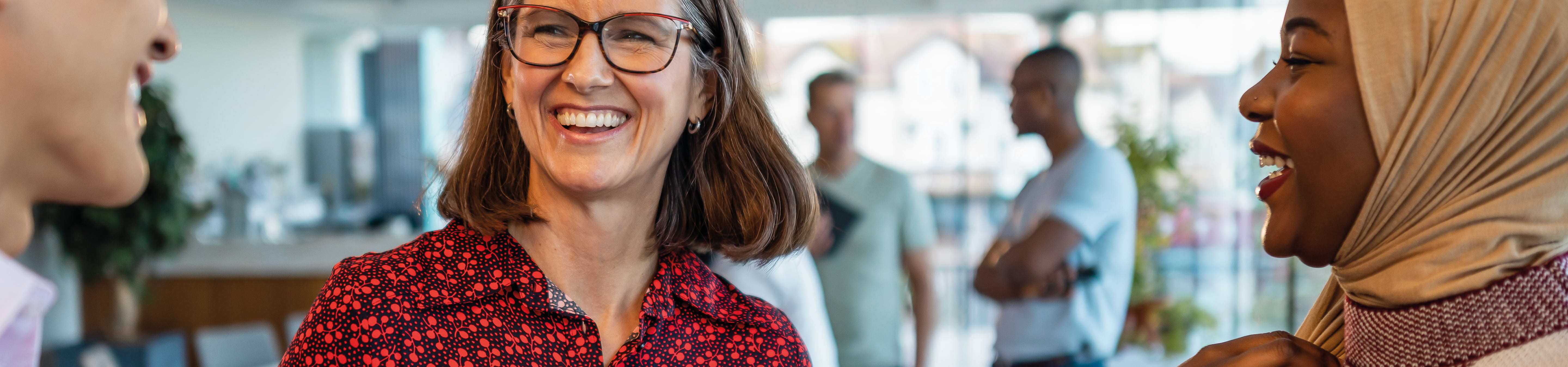 office workers smiling and having a conversation