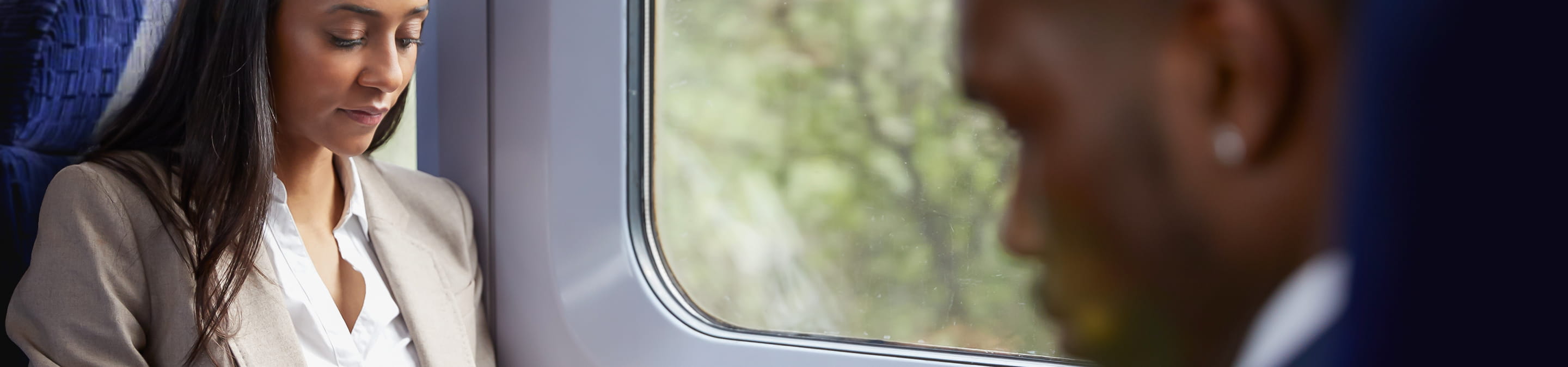 a woman and a man on the train on their way to work