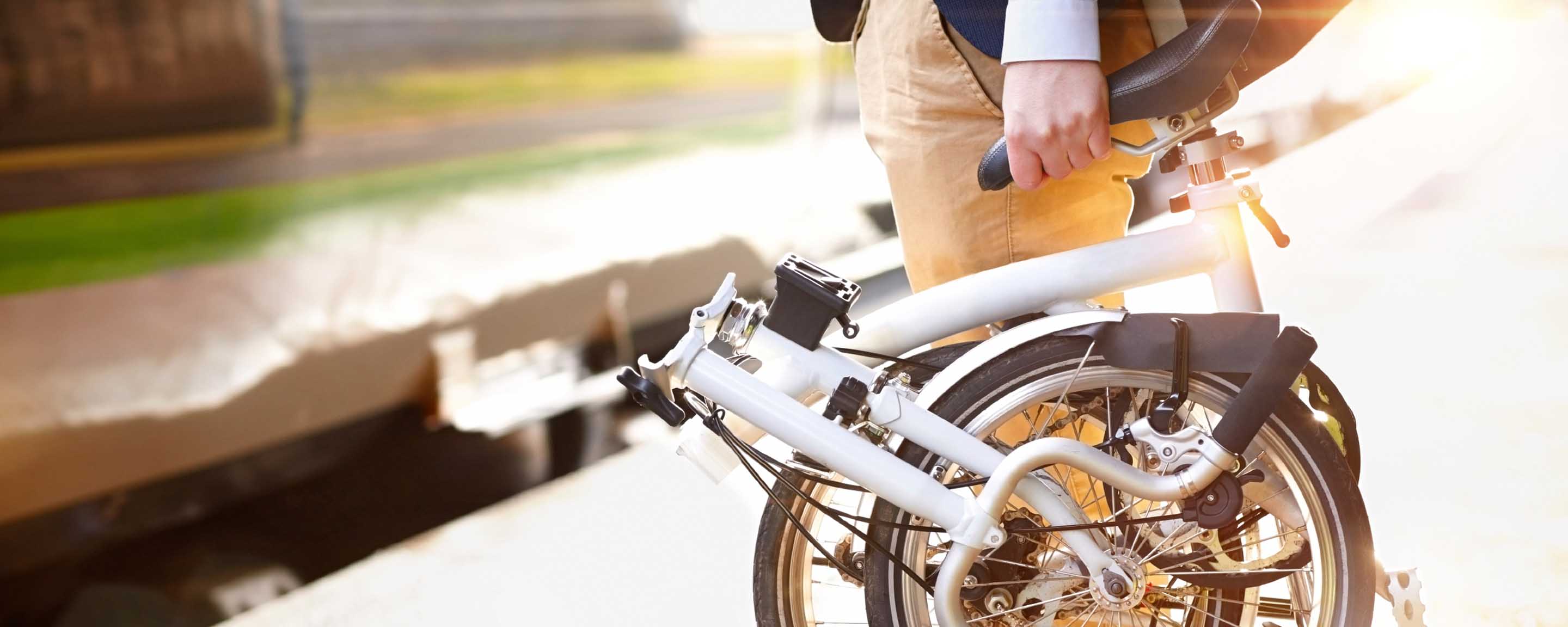 Man holding portable bicycle