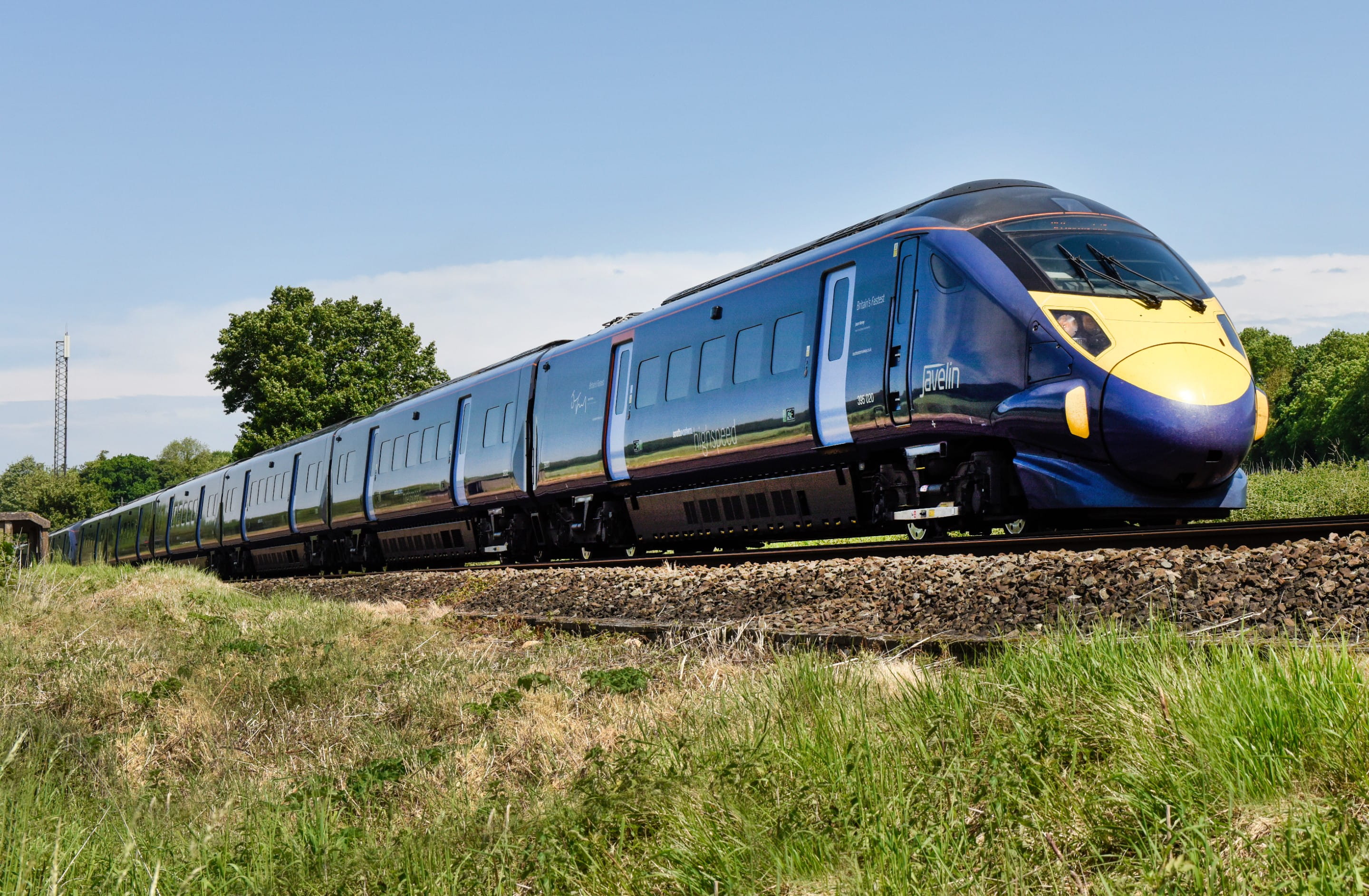 Blue train travelling across countryside