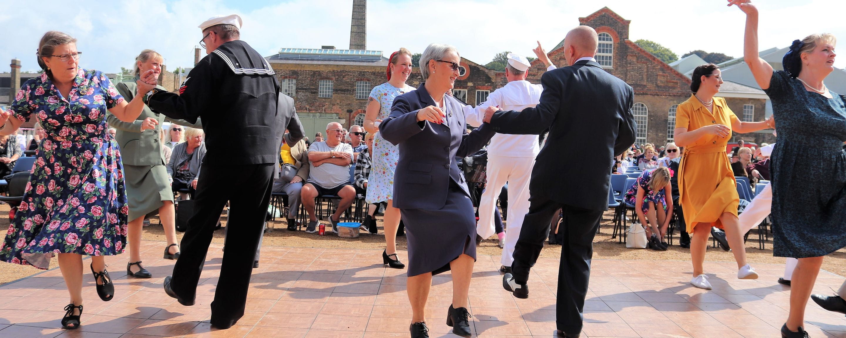 people doing swing music on stage in 40s clothing