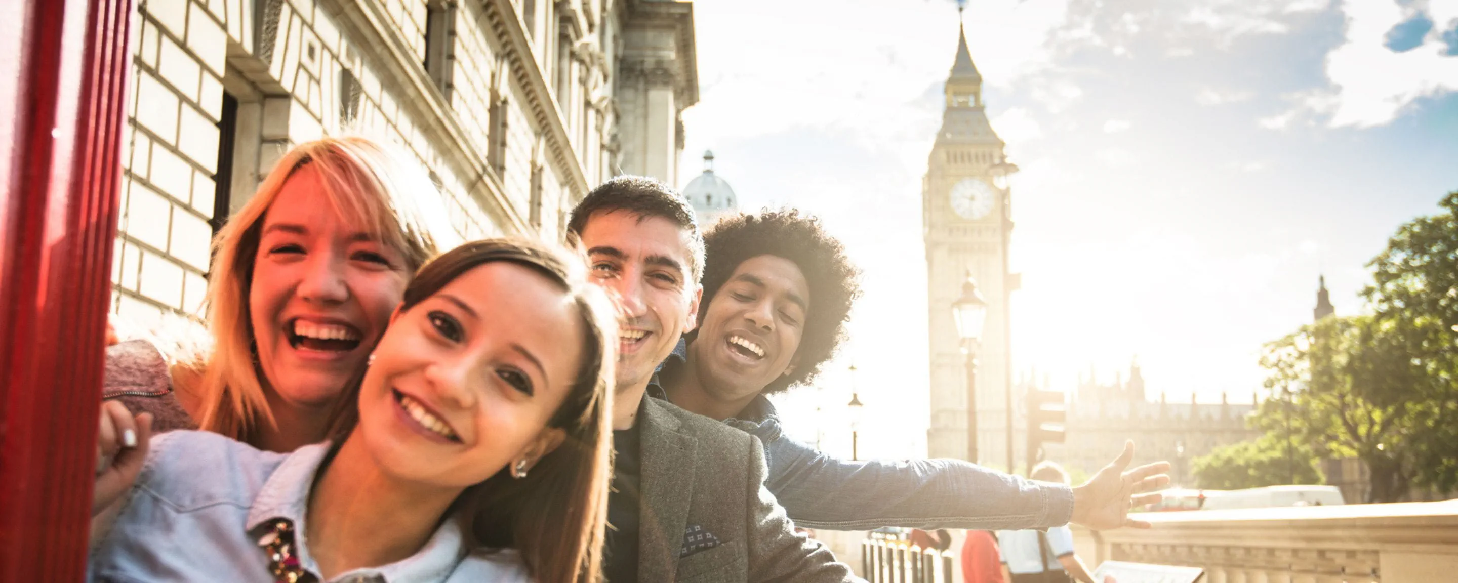 a group of friends posing for a photo in front of Big Ben