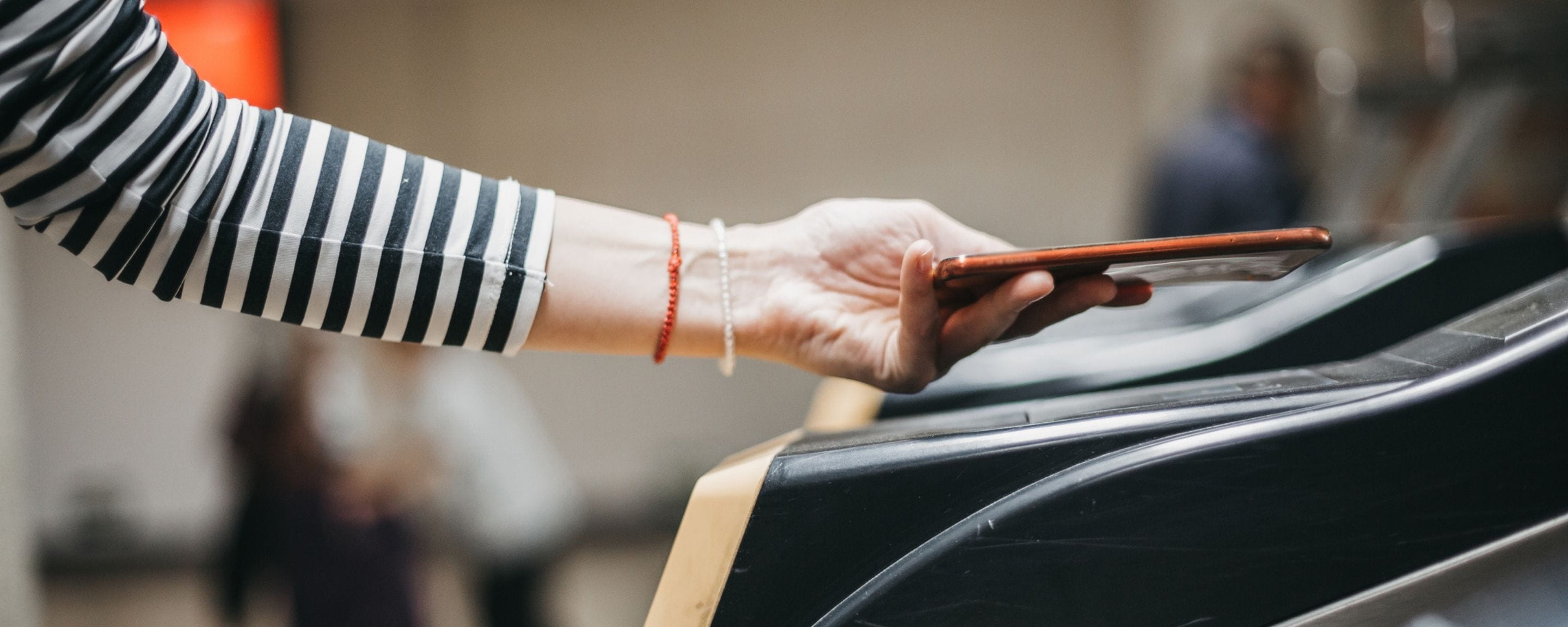 a person using their phone to tap in at a station