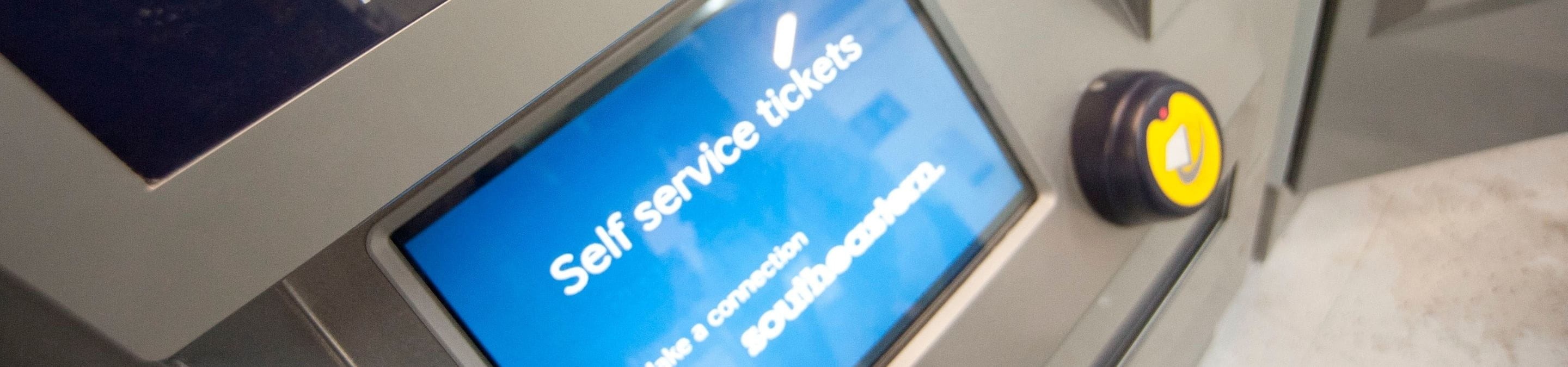 a woman using a ticket at a train station