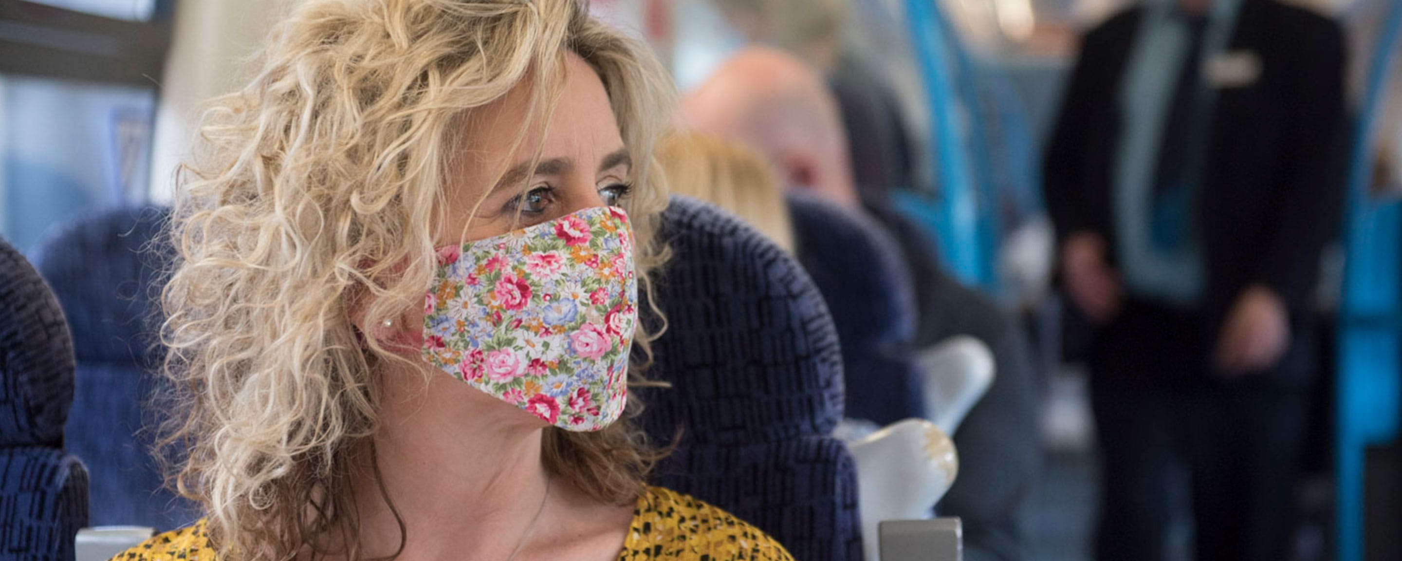 Woman wearing face mask on board train