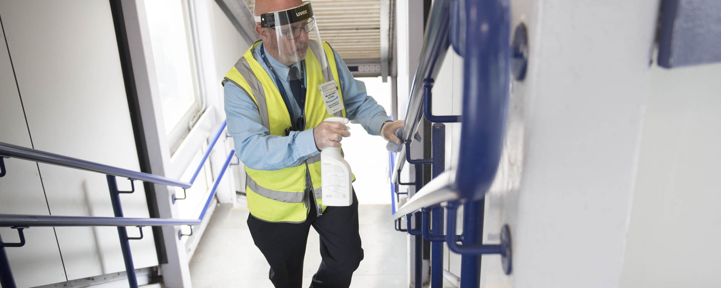 Station staff cleaning a hand rail