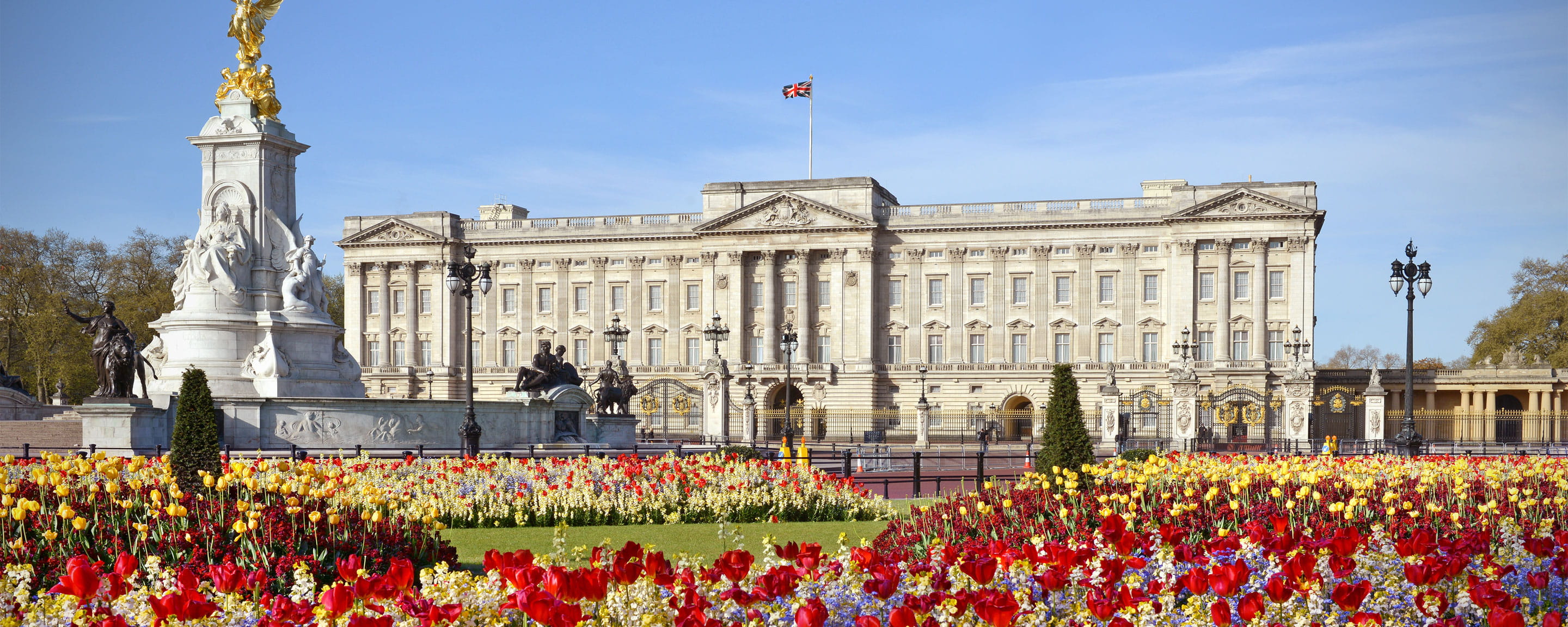 Buckingham Palace with bright flowers in the foreground 
