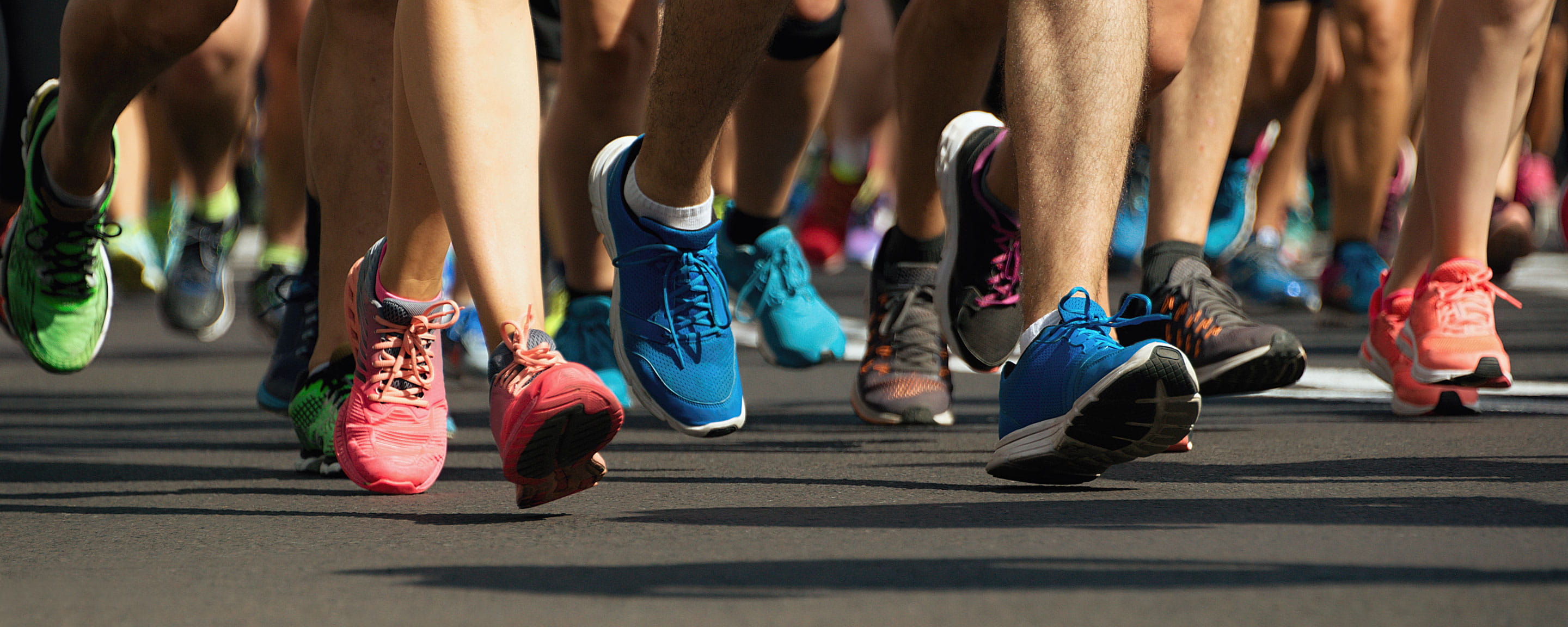 Runners legs and colourful trainers