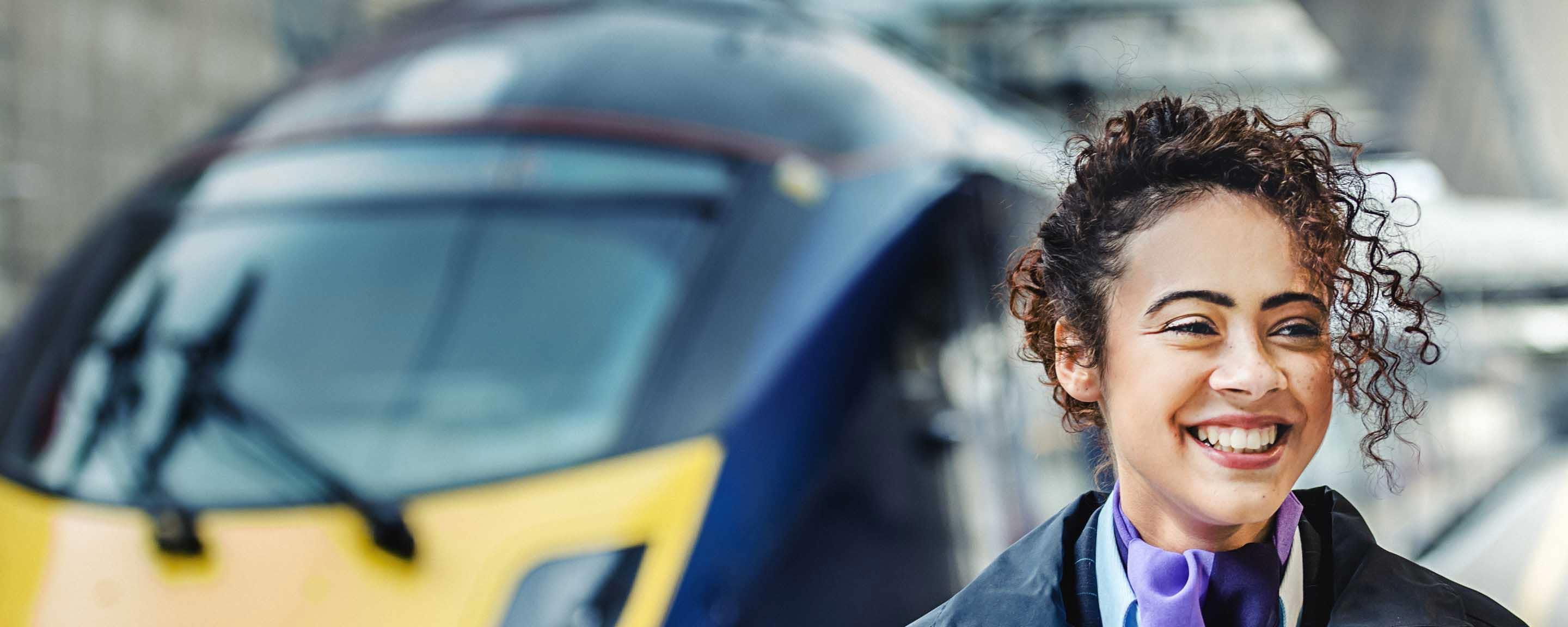 Smiley woman next to train