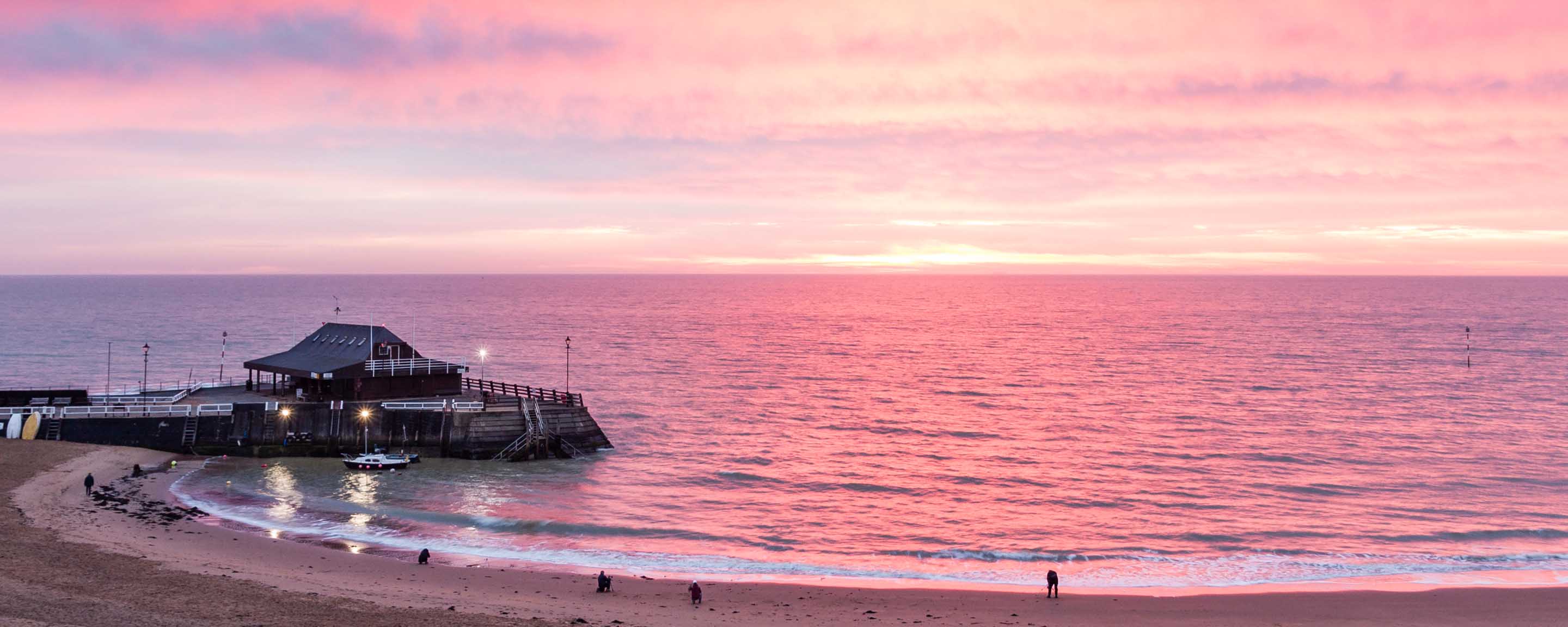 Beach pier by sunset