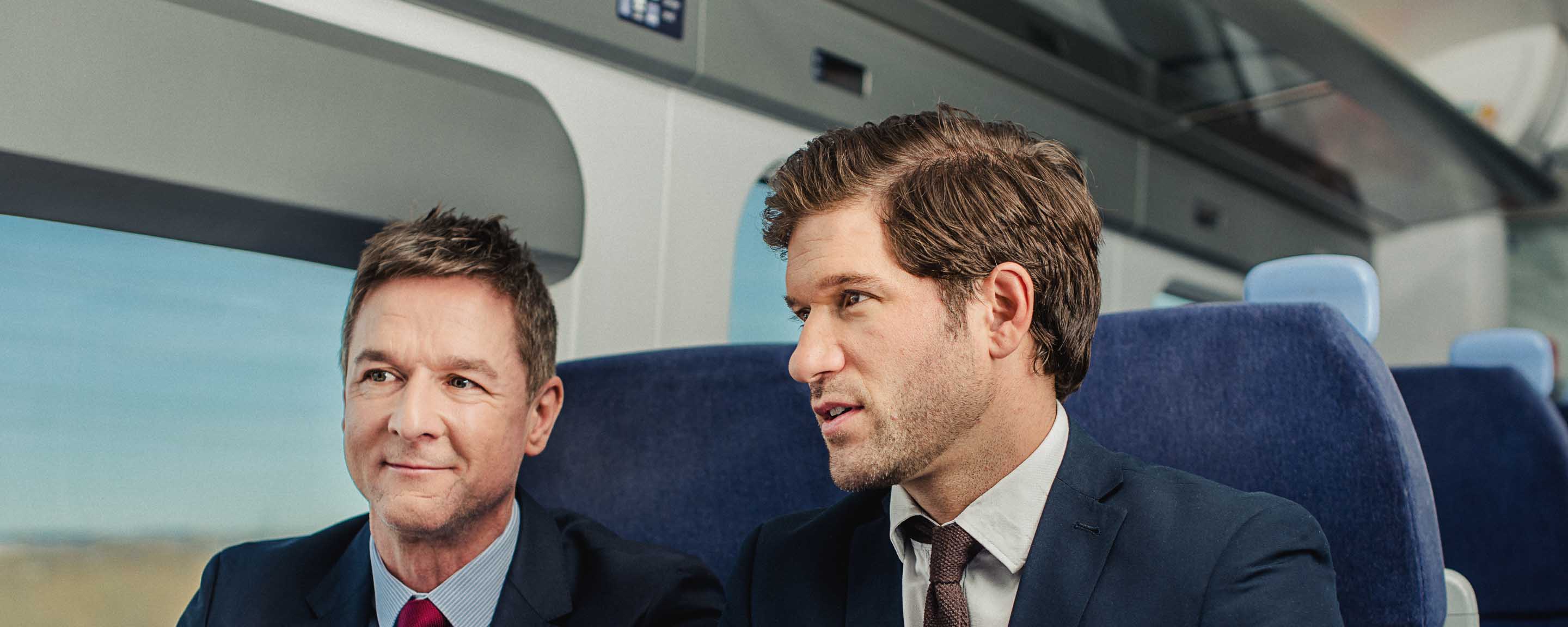 Two men in train chatting