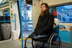 a man in a wheelchair on board a train