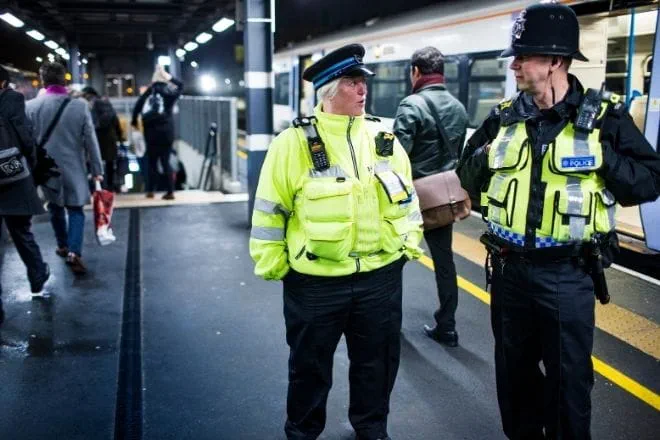 two revenue officers working at a train station