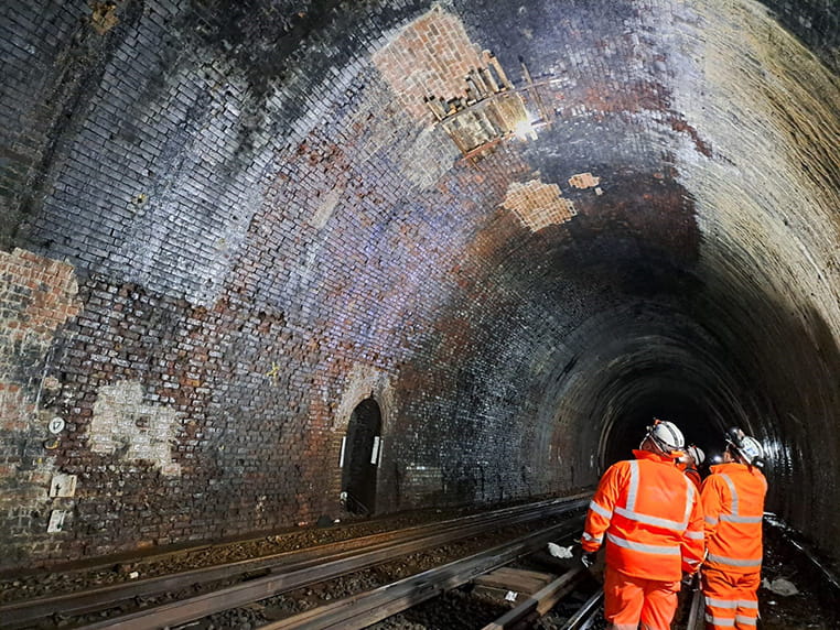 Blackheath tunnel with repair workers walking through
