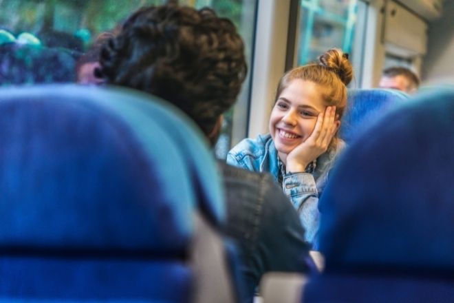 a woman smiling on a train