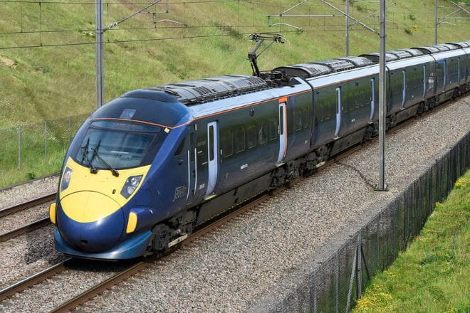 a train traveling through a lush green field