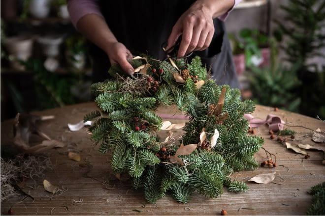 Person making a Christmas wreath