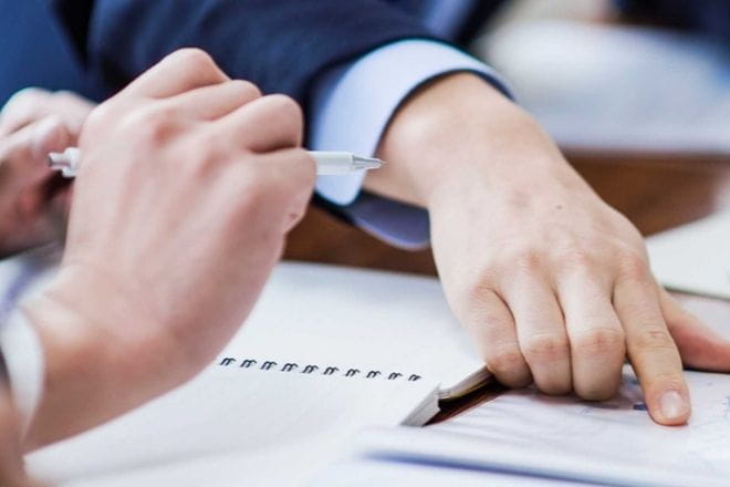 a person cutting a piece of paper