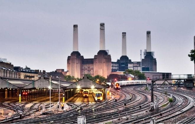 a train on a train track with buildings in the background