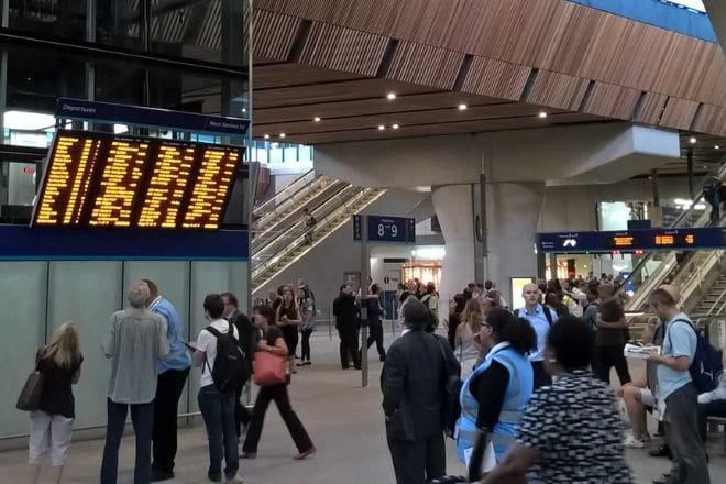 a group of people waiting for their luggage at an airport