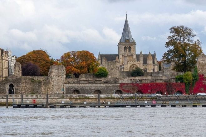 a castle with water in front of a building