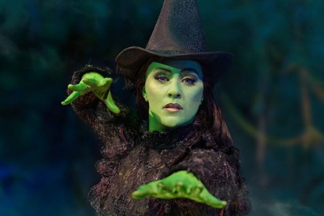 The green wicked witch in her black hat and cloak