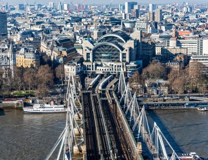 a bridge over water with a city in the background