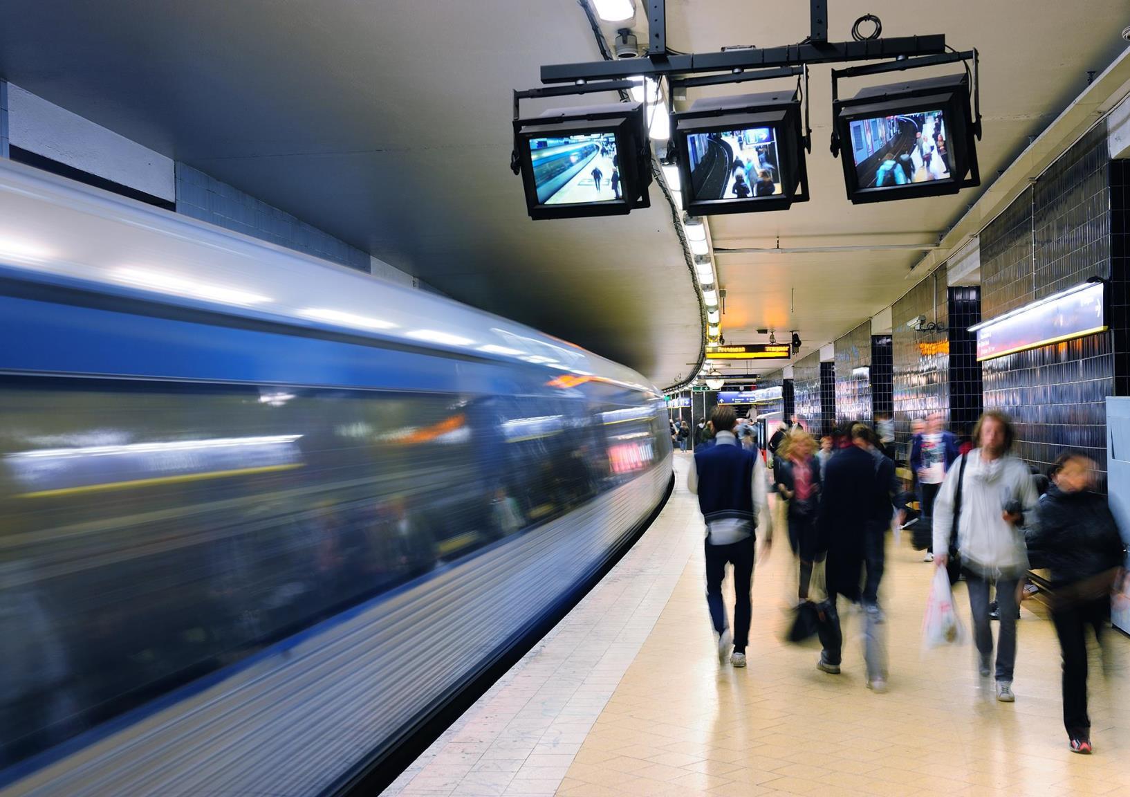 a group of people standing in a train station