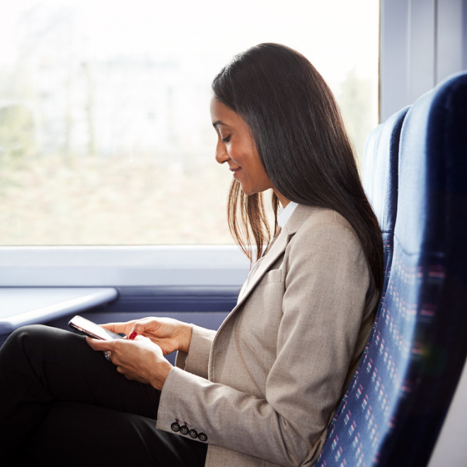 woman using phone on train